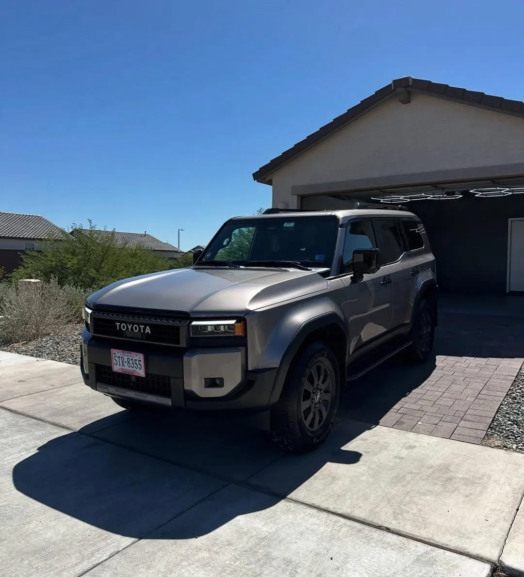 Gray Toyota SUV shining in a driveway after a detail